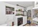 Functional laundry room with washer, dryer, storage shelves and a window at 3927 Vasco St, Punta Gorda, FL 33950