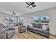 Bright living room features hardwood floors, comfortable gray furniture and lots of natural light at 3927 Vasco St, Punta Gorda, FL 33950