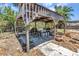 Outdoor dining area with a pergola and a stone countertop, offering a pleasant space for outdoor meals and entertaining at 3927 Vasco St, Punta Gorda, FL 33950