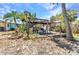 Backyard featuring an outdoor kitchen with a wooden pergola, creating a perfect spot for relaxation and outdoor activities at 3927 Vasco St, Punta Gorda, FL 33950
