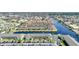 Aerial view showcases a waterfront community with canals, boat docks, parking, and lush landscaping at 4000 E Bal Harbor Blvd. E. #211 # 211, Punta Gorda, FL 33950