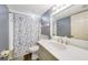 Well-lit bathroom featuring a vanity, shower with starfish curtain and a toilet at 4000 E Bal Harbor Blvd. E. #211 # 211, Punta Gorda, FL 33950