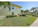 Building 2, shows corner unit with healthy green lawn and vegetation at 4000 E Bal Harbor Blvd. E. #211 # 211, Punta Gorda, FL 33950