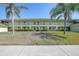 Exterior shot of a two-story condo building featuring balconies, lush landscaping, and well-maintained grounds at 4000 E Bal Harbor Blvd. E. #211 # 211, Punta Gorda, FL 33950