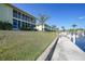 Exterior view of a condo complex with palm trees, balconies, and waterfront access from a shared pier at 4000 E Bal Harbor Blvd. E. #211 # 211, Punta Gorda, FL 33950