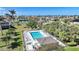 Community pool with ample seating and lush landscaping in a quiet neighborhood, under a bright blue sky at 4000 E Bal Harbor Blvd. E. #211 # 211, Punta Gorda, FL 33950