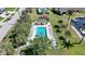 Aerial view of a community pool with sun loungers and a charming pool house, surrounded by greenery at 4000 E Bal Harbor Blvd. E. #211 # 211, Punta Gorda, FL 33950