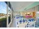 Spacious sunroom featuring canal view, multiple dining sets and direct access to other rooms at 4000 E Bal Harbor Blvd. E. #211 # 211, Punta Gorda, FL 33950