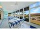Bright sunroom with canal view, dining set, tile floor and ceiling fans at 4000 E Bal Harbor Blvd. E. #211 # 211, Punta Gorda, FL 33950