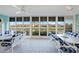 Expansive sunroom with canal views, multiple tables and ceiling fans, perfect for entertaining at 4000 E Bal Harbor Blvd. E. #211 # 211, Punta Gorda, FL 33950