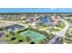Aerial view of a community tennis court, surrounded by lush landscaping and residential streets at 4000 E Bal Harbor Blvd. E. #211 # 211, Punta Gorda, FL 33950