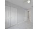 Bright bedroom featuring a ceiling fan and three white closets at 4243 Hokan Ave, North Port, FL 34287