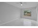 This bedroom has a ceiling fan and large window with a view at 4243 Hokan Ave, North Port, FL 34287