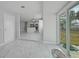 Bonus room featuring marble floors with views of the kitchen and backyard at 4243 Hokan Ave, North Port, FL 34287