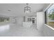 Open floor plan with stylish kitchen island, modern lighting fixtures, and stainless steel appliances at 4243 Hokan Ave, North Port, FL 34287