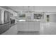 Beautiful white kitchen with stainless steel appliances, granite counters, and an island with seating at 4243 Hokan Ave, North Port, FL 34287