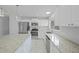 Modern kitchen features stainless steel appliances, granite countertops and island with breakfast bar at 4243 Hokan Ave, North Port, FL 34287
