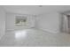 Bright living room featuring new flooring, fresh paint, and ample natural light from a large window at 4243 Hokan Ave, North Port, FL 34287