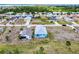 An aerial view of a quiet neighborhood with a charming blue home at 4285 Oak Terrace Cir, Port Charlotte, FL 33953