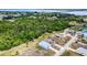 An aerial view showcases a quaint neighborhood with homes nestled amongst natural landscaping at 4285 Oak Terrace Cir, Port Charlotte, FL 33953