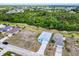 Aerial view of a charming blue single-Gathering home, complemented by green surroundings and a spacious driveway at 4285 Oak Terrace Cir, Port Charlotte, FL 33953