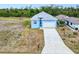 Aerial view of charming home with a two-car garage and a concrete driveway at 4285 Oak Terrace Cir, Port Charlotte, FL 33953
