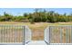 View of backyard steps leading to natural landscaping and mature trees at 4285 Oak Terrace Cir, Port Charlotte, FL 33953