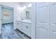 Bright bathroom with double sink vanity, medicine cabinet mirror, leading to an open bedroom space at 4285 Oak Terrace Cir, Port Charlotte, FL 33953