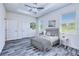 A bright bedroom features a decorative ceiling, a ceiling fan, and large windows that allow for natural light at 4285 Oak Terrace Cir, Port Charlotte, FL 33953
