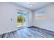 Bright bedroom featuring sliding doors to a patio and a window for natural light at 4285 Oak Terrace Cir, Port Charlotte, FL 33953