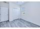 Bright bedroom with gray wood-look flooring, white trim, a closet, and natural light at 4285 Oak Terrace Cir, Port Charlotte, FL 33953