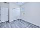 Bright bedroom with gray wood-look flooring, white trim, a closet, and natural light at 4285 Oak Terrace Cir, Port Charlotte, FL 33953