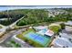 Aerial view featuring a community pool, tennis court, and recreational area perfect for relaxation and activities at 4285 Oak Terrace Cir, Port Charlotte, FL 33953