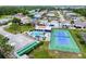 Aerial view featuring a community pool, tennis court, and shuffleboard near many single Gathering homes at 4285 Oak Terrace Cir, Port Charlotte, FL 33953