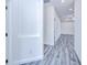 Hallway featuring modern floors, base trim, and crisp, white walls leading to other rooms at 4285 Oak Terrace Cir, Port Charlotte, FL 33953