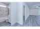Hallway view including a bathroom featuring tub and shower and view to living area at 4285 Oak Terrace Cir, Port Charlotte, FL 33953
