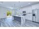 Contemporary kitchen featuring stainless steel appliances, quartz countertops, and a stylish island at 4285 Oak Terrace Cir, Port Charlotte, FL 33953