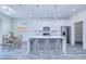 Bright kitchen features a center island, modern appliances, and a dining area with contemporary chandelier at 4285 Oak Terrace Cir, Port Charlotte, FL 33953