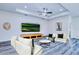 Bright living room features hardwood floors, modern ceiling fan, and cozy seating area at 4285 Oak Terrace Cir, Port Charlotte, FL 33953