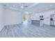 Open-concept living space with a modern kitchen, dining area, and sliding doors to the outside at 4285 Oak Terrace Cir, Port Charlotte, FL 33953