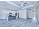 Open-concept living space featuring a modern kitchen, island, and stylish flooring at 4285 Oak Terrace Cir, Port Charlotte, FL 33953