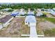 Aerial view of the home showcasing the roof, driveway, and surrounding neighborhood at 4290 Oak Terrace Cir, Port Charlotte, FL 33953