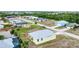 A beautiful home surrounded by greenery and other well-maintained homes, offering a serene setting at 4290 Oak Terrace Cir, Port Charlotte, FL 33953