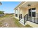 The back of the house features a covered patio and black railings overlooking the backyard at 4290 Oak Terrace Cir, Port Charlotte, FL 33953