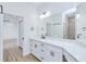 Bathroom featuring a white vanity with quartz countertop, decorative lighting and glass enclosed shower at 4290 Oak Terrace Cir, Port Charlotte, FL 33953