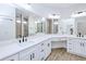 Spacious bathroom featuring a white vanity with double sinks, quartz countertop and modern fixtures at 4290 Oak Terrace Cir, Port Charlotte, FL 33953