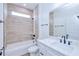 Modern bathroom featuring a sleek vanity, stylish tile, and a shower-tub combination at 4290 Oak Terrace Cir, Port Charlotte, FL 33953
