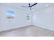 Bright bedroom with natural light, ceiling fan, light wood-look floors, and white walls at 4290 Oak Terrace Cir, Port Charlotte, FL 33953