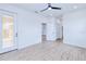 Bedroom features wood-look flooring, recessed lights, a ceiling fan, and an exterior patio entrance at 4290 Oak Terrace Cir, Port Charlotte, FL 33953