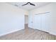 Bedroom featuring wood-look floors, a ceiling fan and closet at 4290 Oak Terrace Cir, Port Charlotte, FL 33953